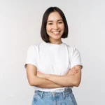 portrait-happy-asian-woman-smiling-posing-confident-cross-arms-chest-standing-against-studio-background_1258-89269 - The Skin Suite